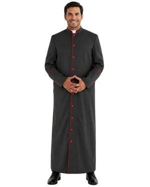 A man modeling a long dark gray clerical cassock with red trim and red buttons, standing against a plain white background.