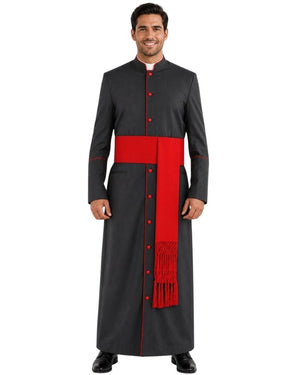 A man modeling a long black clerical cassock with a wide red waist sash and a red vertical panel with red fringe, shown against a plain white background.