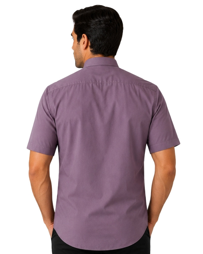 Man wearing a gray clerical shirt with a white collar on a white background