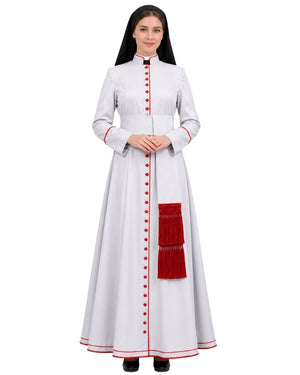 A woman modeling a Pious White Anglican Cassock With Red Trim, red decorative buttons down the front, and a large red fringed pocket on the side, photographed against a plain white background.