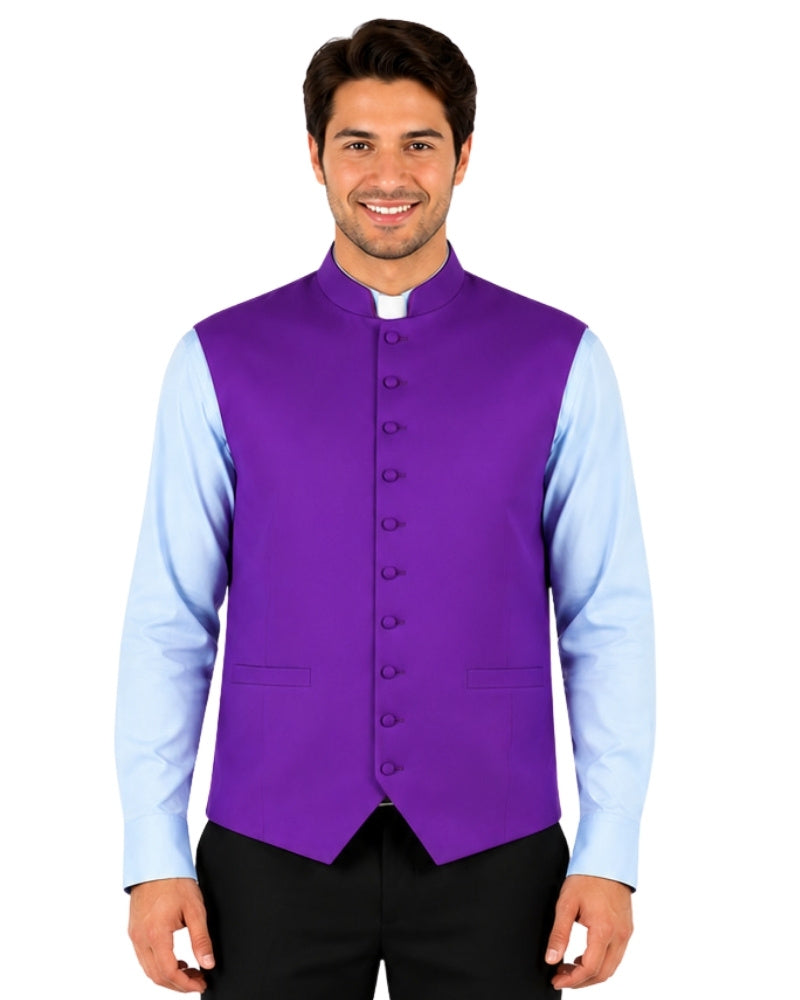 Man wearing a purple vest over a light blue shirt with black pants on a white background.