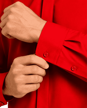 Close-up of a man hands adjusting a red dress shirt cuff, showing the red buttons and fabric texture.