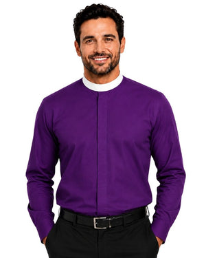A smiling man wearing a purple long-sleeve clerical shirt with a white mock neck collar, paired with black trousers and a black belt, against a plain white background.