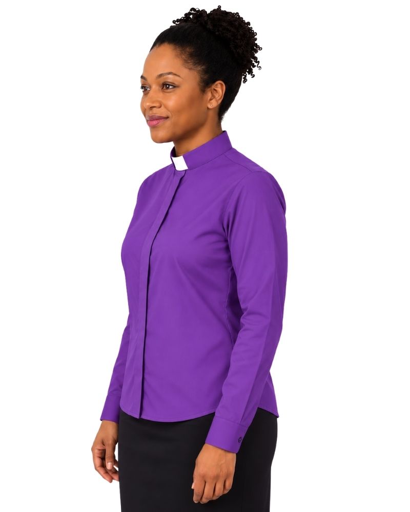 A woman wearing a purple long-sleeve clerical shirt with a white collar, paired with black trousers, shown from a side profile against a white background.