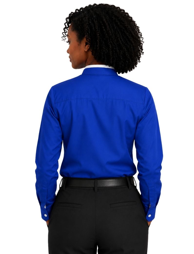 A woman shown from the back wearing a bright royal blue long-sleeve clerical shirt tucked into black dress pants with a black belt, against a plain white background.