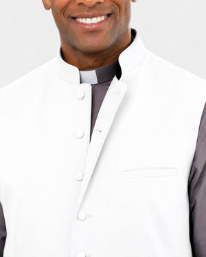 Man wearing a white lab coat with a gray shirt underneath on a light gray background