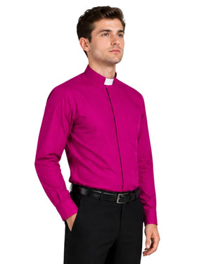 Man wearing a bright pink shirt and black pants on a white background
