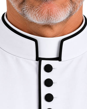 Close-up of a White Clergy Cassock With Black Trim and black buttons down the front, worn by a man with a gray beard.