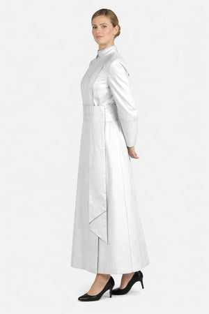 Woman wearing a long white robe with a high collar on a white background