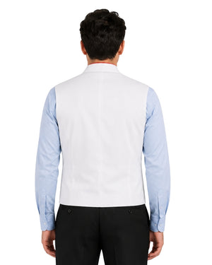 Man wearing a light blue clerical shirt white vest on a white background.