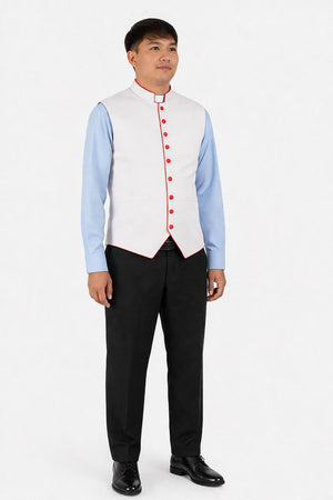 Man wearing a light blue shirt with a white vest with bright orange and black pants on a white background