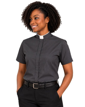 A woman modeling a dark gray short-sleeve clerical shirt with a white collar, paired with black trousers and a black belt, against a plain white background.