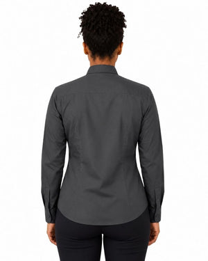 A woman viewed from the back wearing a dark charcoal gray long-sleeve clerical shirt and black pants, set against a plain white background.