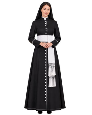 A woman modeling a Black Clergy Cassock with a white waistband, white vertical button placket, and a white sash with fringe, photographed against a plain white background.
