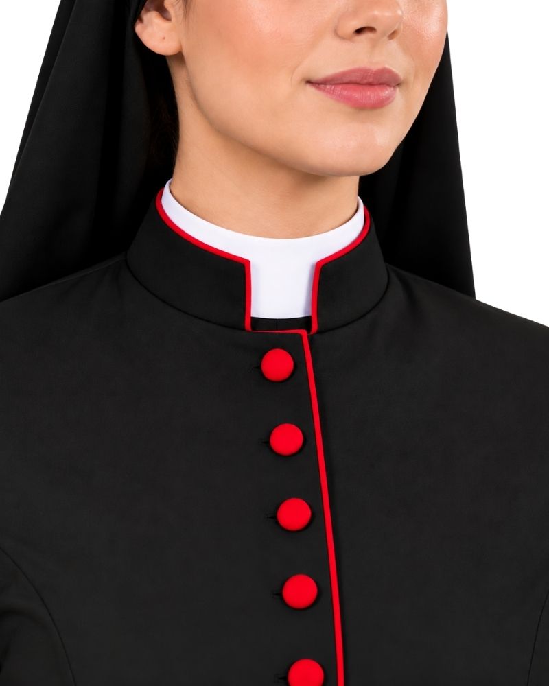 Close-up of a woman wearing a Cardinal Black Cassock With Scarlet Piping with a white collar and red trim and red buttons, against a plain white background.