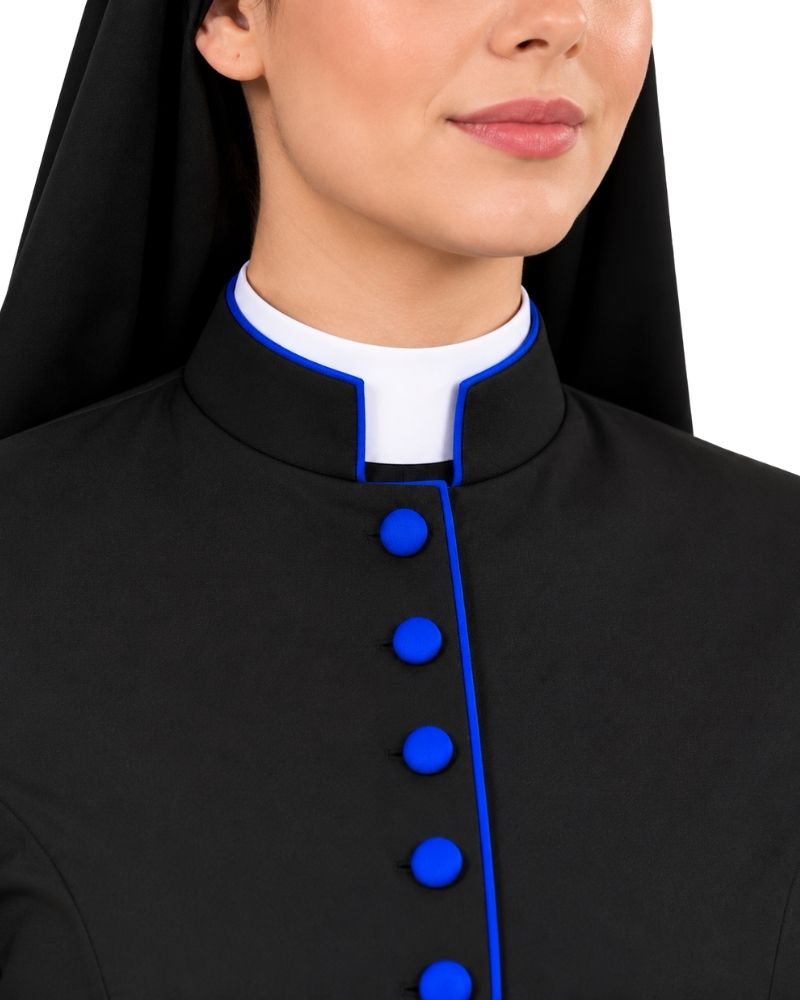 A close-up of a woman wearing a Cassock Black With Royal Blue Trim and blue buttons over a white collar, against a plain white background.