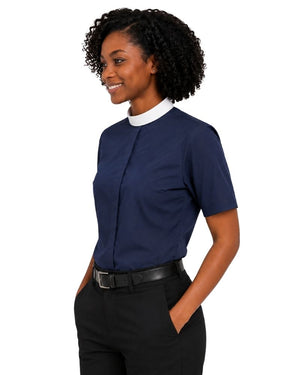 A woman wearing a navy blue short-sleeve collared blouse with a white clerical neck collar, paired with black trousers and a black belt, shown against a plain white background.