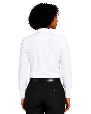 A woman shown from the back wearing a white long-sleeve clerical shirt tucked into black trousers with a black belt, against a plain white background.