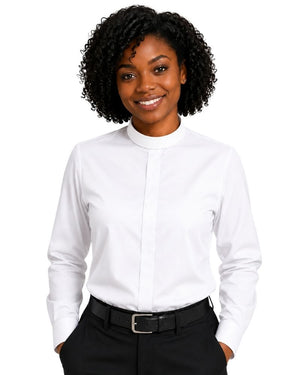 A woman with curly black hair wearing a white long-sleeve clerical shirt with a mock neck, paired with black trousers and a black belt, against a plain white background.