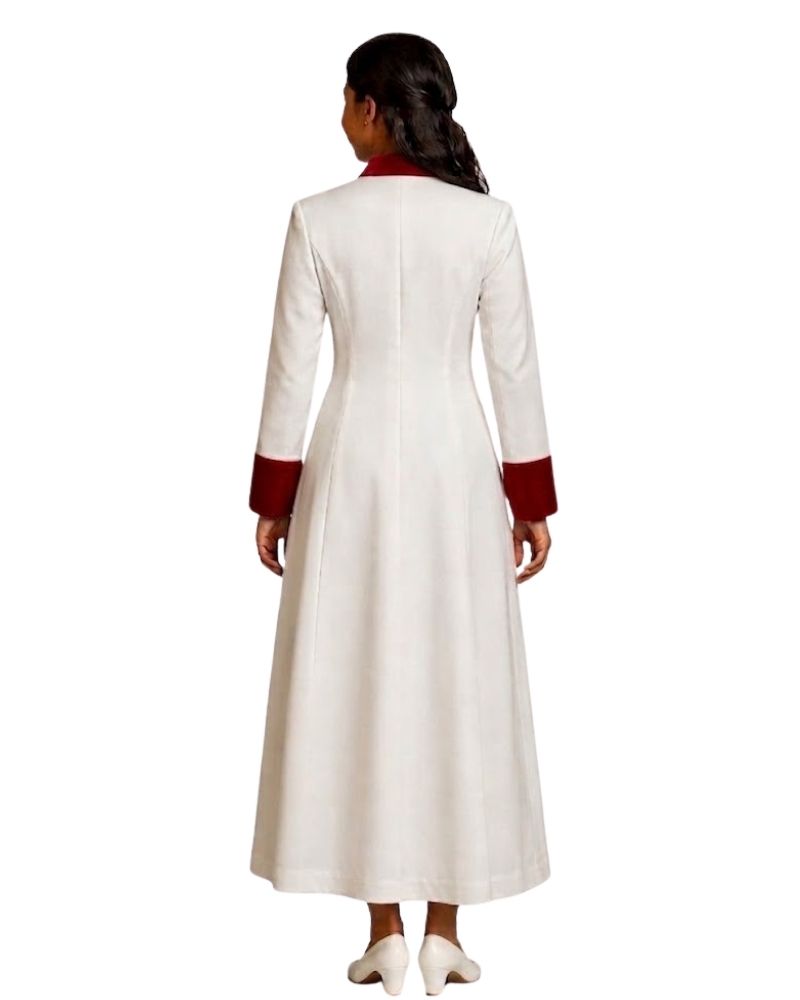 A woman viewed from the back wearing a long white robe with contrasting dark red collar and cuff details, set against a plain white background.