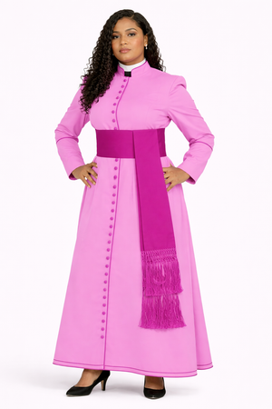 Woman wearing a pink traditional outfit with a belt and fringes on a white background