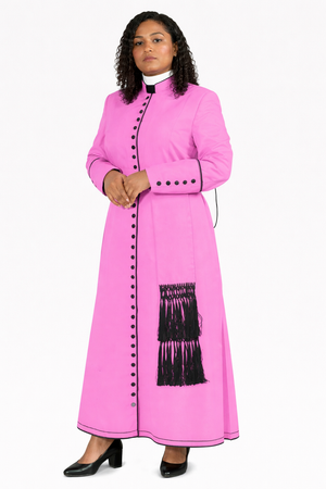 Woman wearing a pink dress with black buttons and fringes on a white background