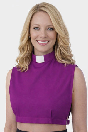 Woman wearing a purple clerical collar shirt on a white background