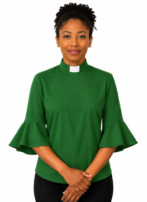 Woman wearing a green clergy shirt with a white collar on a white background