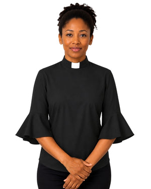 Woman wearing a black clergy shirt with a white collar on a white background.