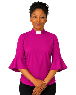 Woman wearing a bright pink clergy shirt with a white collar on a white background.