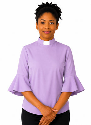 Woman wearing a purple clergy shirt with a white collar on a white background