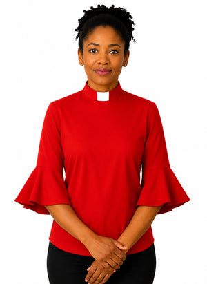 Woman wearing a red blouse with ruffled sleeves on a white background