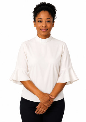 Woman wearing a white shirt with bell sleeves on a white background