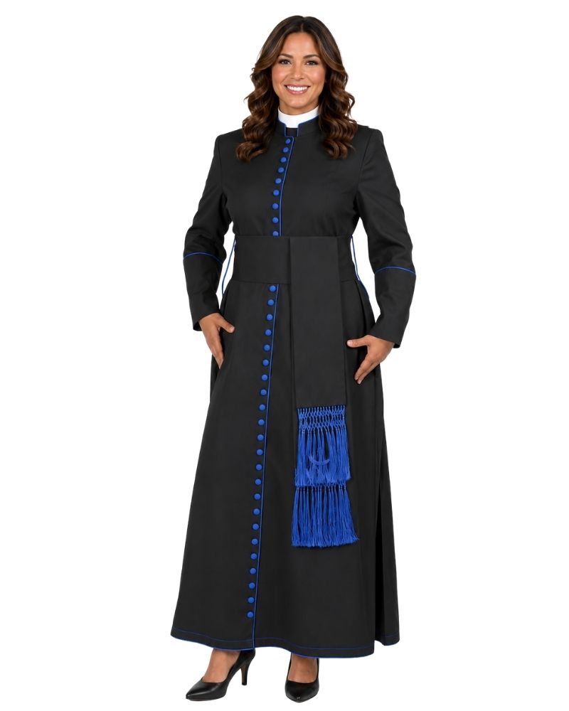 A woman modeling a long black cassock with bright blue button accents, blue piping, and a blue fringe detail on the front, paired with a white collar and black heels, against a plain white background.