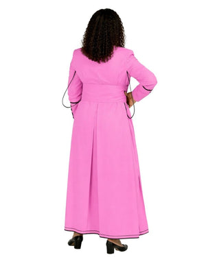 A woman viewed from the back wearing a bright pink cassock with black piping details along the sleeves and hem, set against a plain white background.