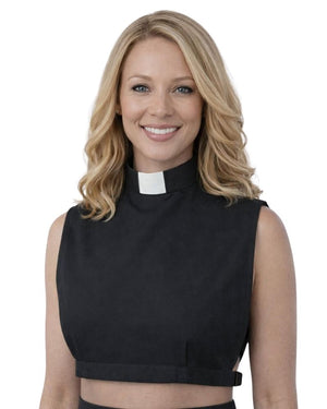 A smiling woman wearing a black sleeveless mock-neck top with a white clerical collar, shown against a plain white background.