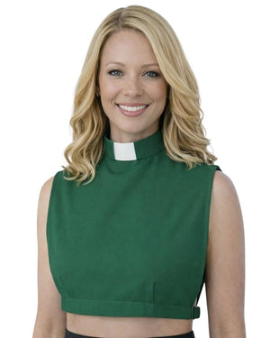 A smiling woman wearing a green sleeveless mock-neck top with a white clerical collar, shown against a plain white background.