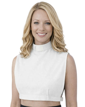 A smiling woman wearing a white sleeveless mock-neck crop top, shown from the chest up against a plain white background.