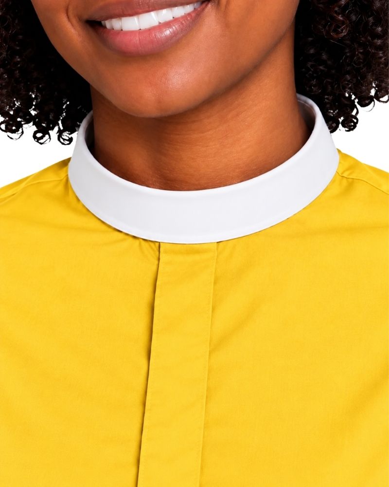 Close-up of a woman wearing a bright yellow clerical shirt with a contrasting white collar, cropped from the mouth down against a plain light background.