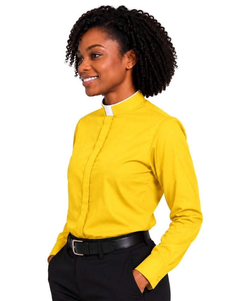A woman with curly black hair wearing a bright yellow long-sleeve clerical shirt with a white collar, paired with black trousers and a black belt, shown against a plain white background.