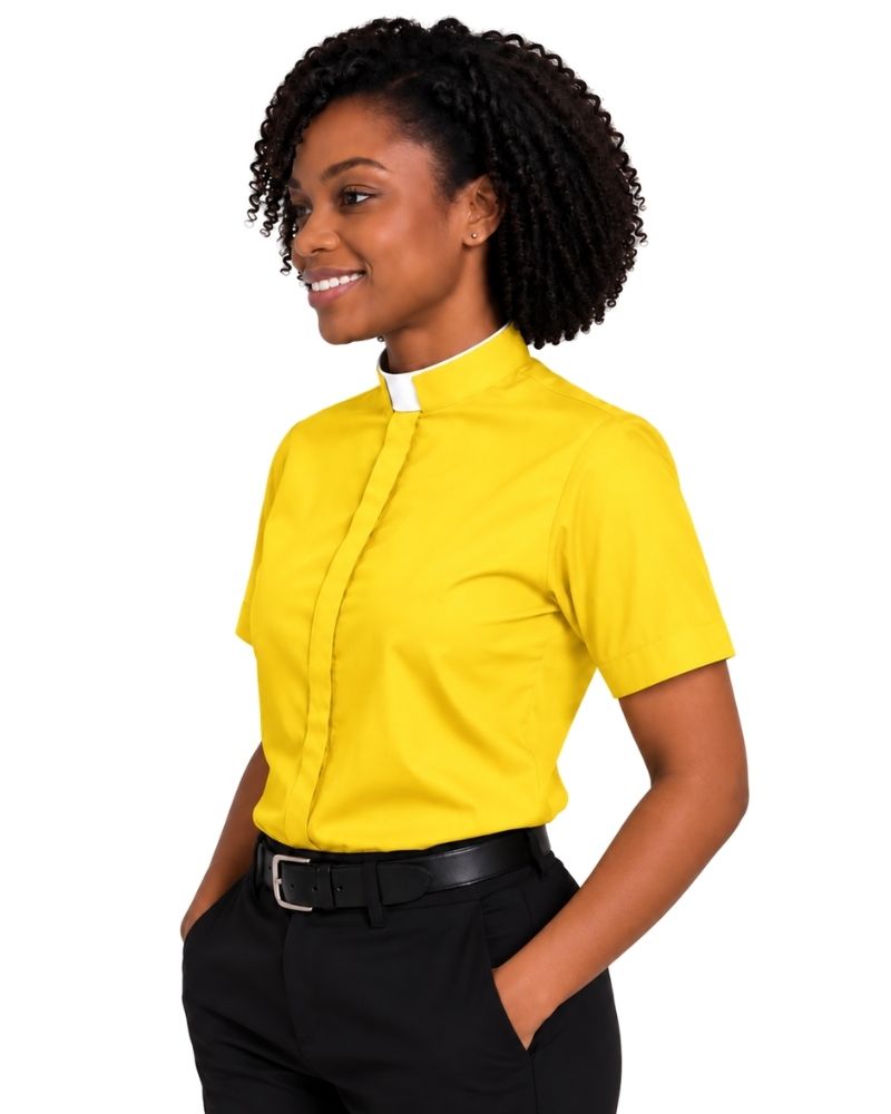 A woman wearing a bright yellow short-sleeve clerical shirt with a white collar, paired with black trousers and a black belt, shown against a plain white background.