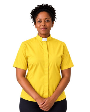 A woman wearing a bright yellow short-sleeve clerical shirt with a white collar tab, paired with black trousers, standing against a plain white background.