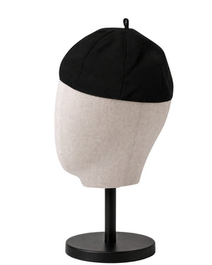 A clergy zucchetto cap displayed on a mannequin head stand against a white background.