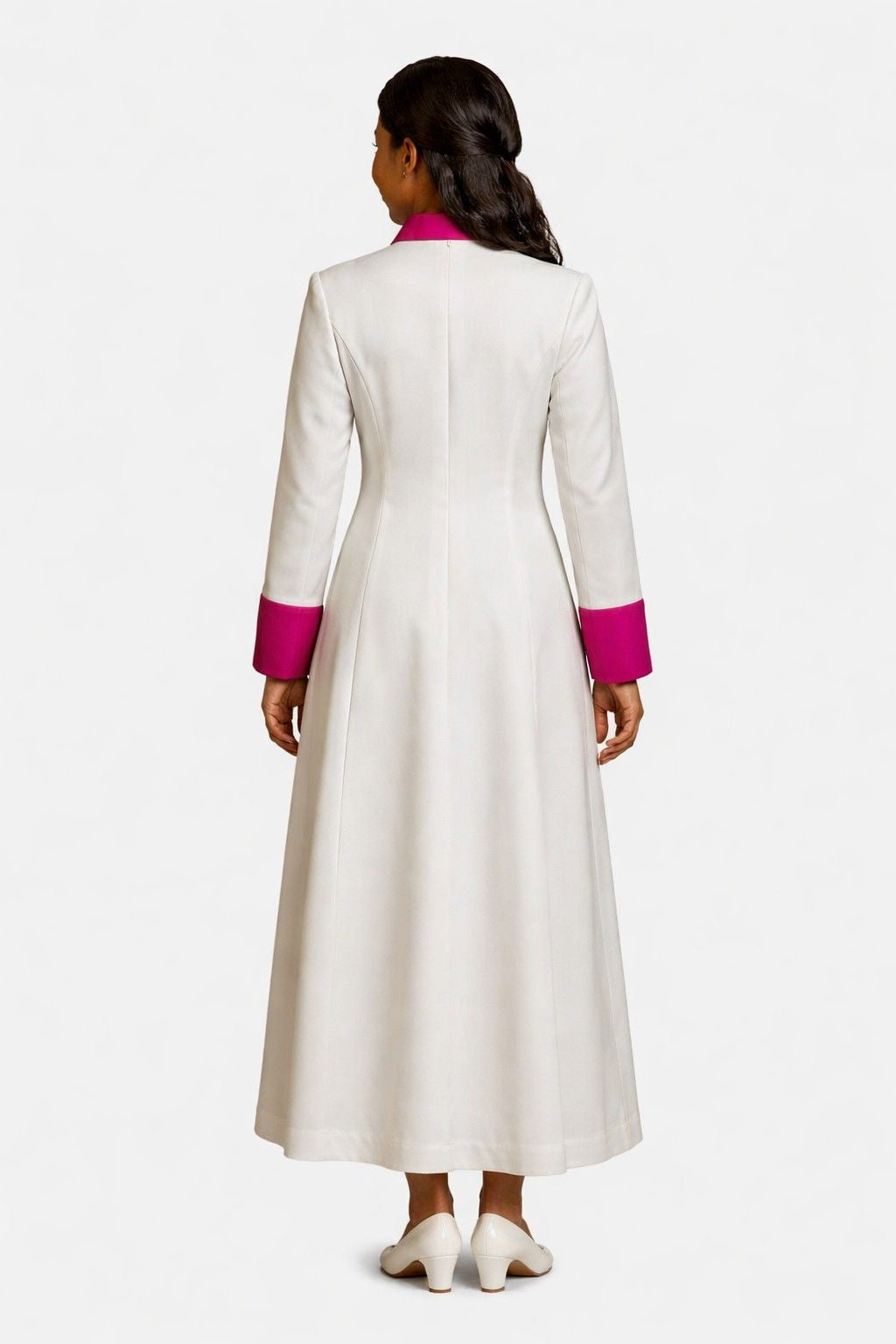 Woman wearing a long white robe with pink accents on a white background
