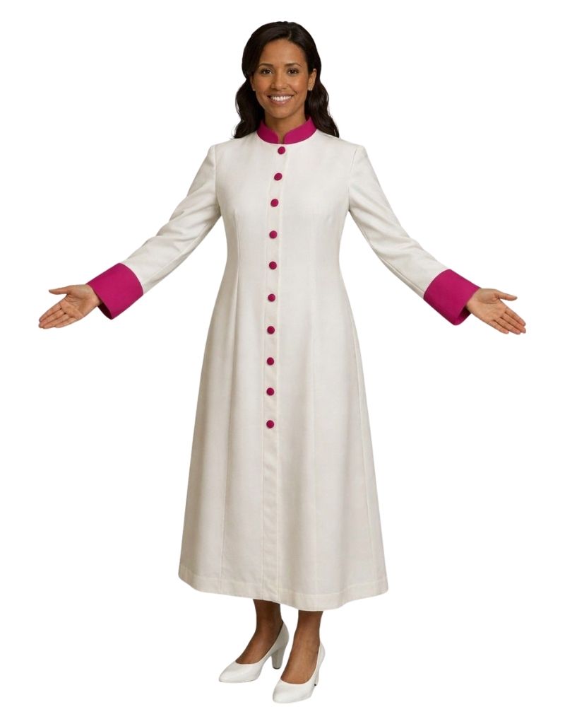 A woman modeling a long white cassock with a bright pink collar and cuffs, featuring a pink button-down front and white heels, set against a plain white background.