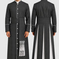Long black robe with white accents worn by a model on a plain background