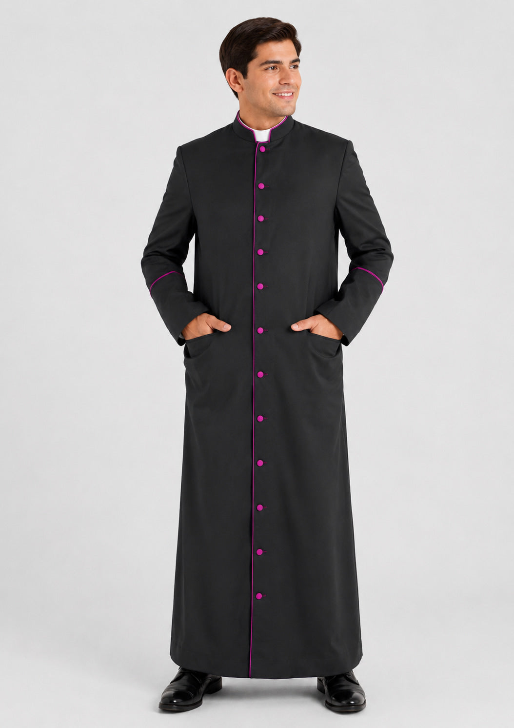 Man wearing a black clerical robe with pink trim on a white background
