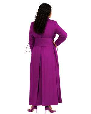 A woman shown from the back wearing a long magenta-purple cassock or robe with long sleeves and a matching waist tie, paired with matching pointed heels, against a plain white background.