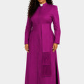 Woman wearing a long purple dress with a matching stole on a white background