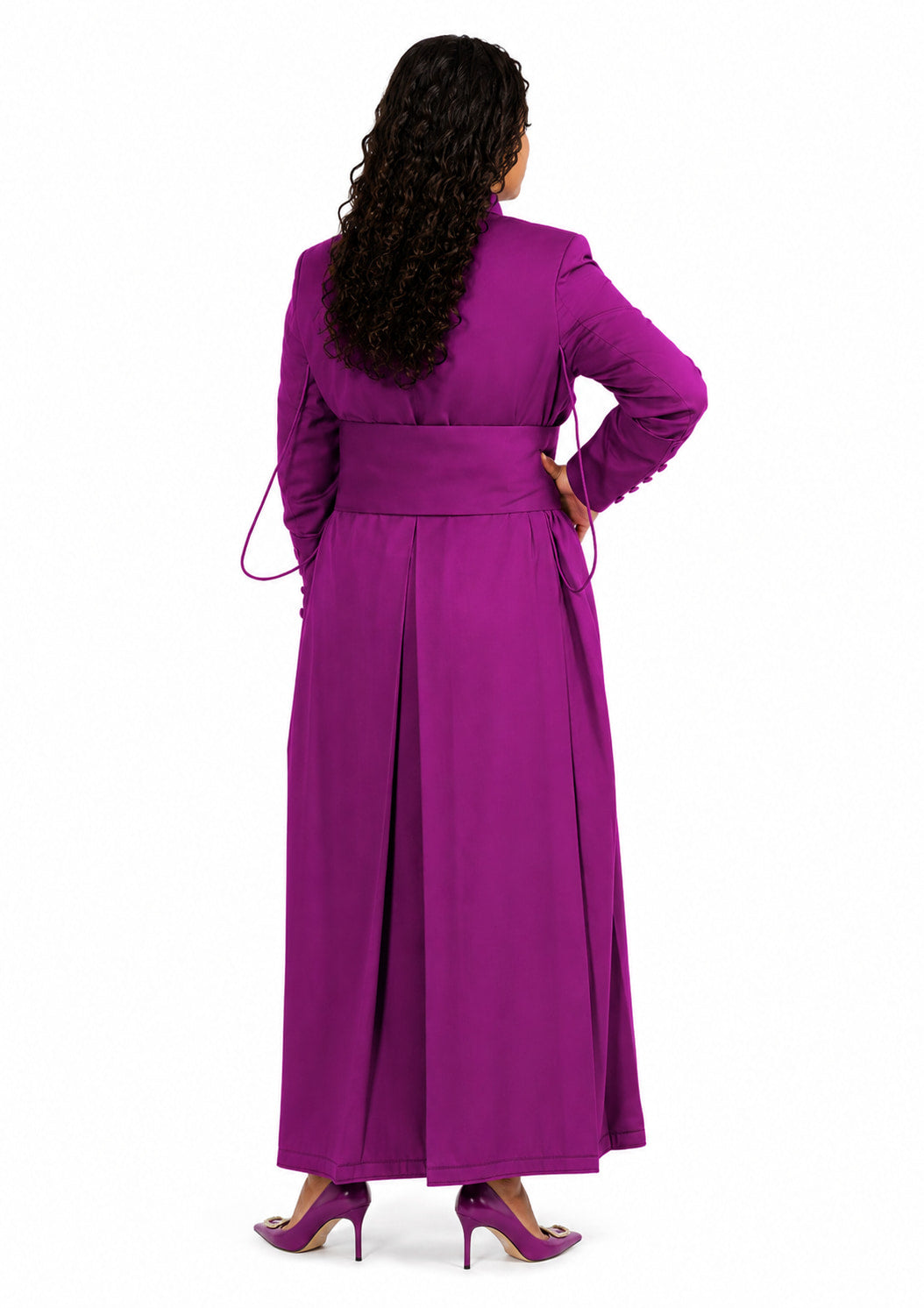 Woman wearing a long purple robe with a sash on a white background